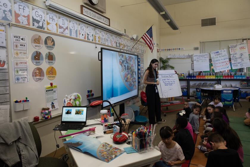 San Diego, CA - October 19: Daniella Brunetto, a teacher at Chollas-Mead Elementary School, gives a reading lesson about the book "Big Al" to a first-grade class on Thursday, Oct. 19, 2023 in San Diego, CA. (Ana Ramirez / The San Diego Union-Tribune)