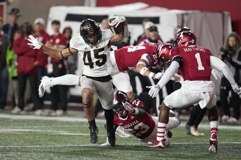 Purdue's Devin Mockobee (45) runs for a touchdown during the second half of an NCAA college football game against Indiana, Saturday, Nov. 26, 2022, in Bloomington, Ind. (AP Photo/Darron Cummings)