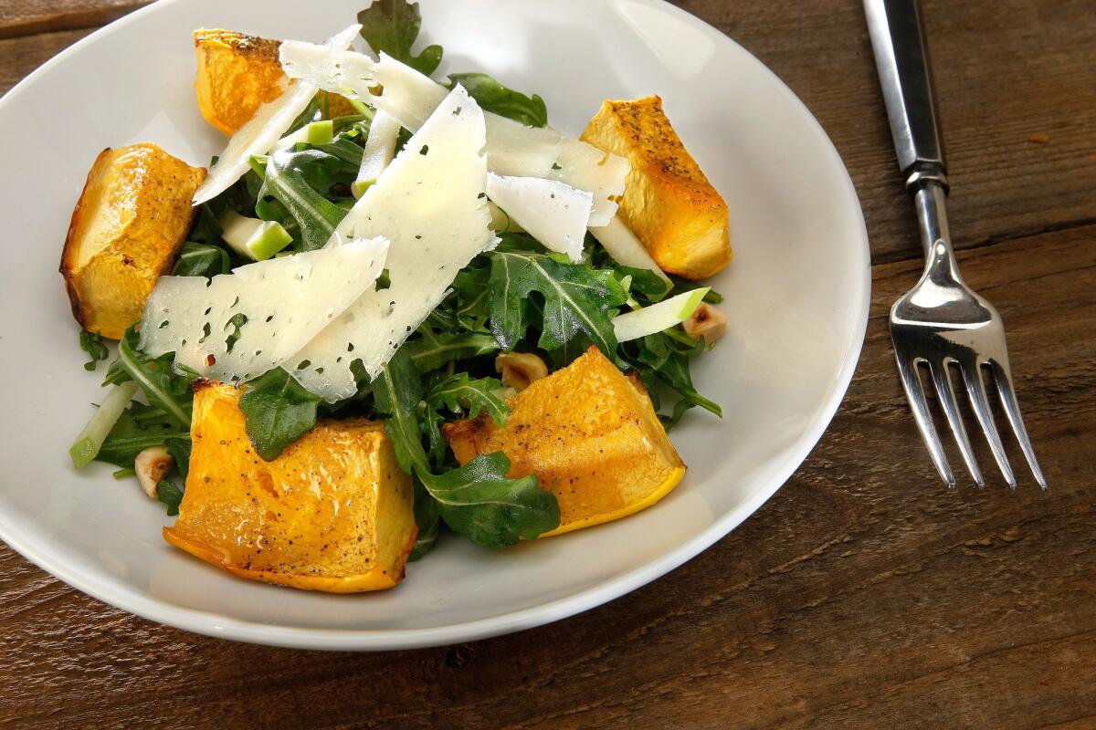 Looking for vegan Thanksgiving options? No problem. Pictured is a roasted acorn squash and apple salad from our recipe database.