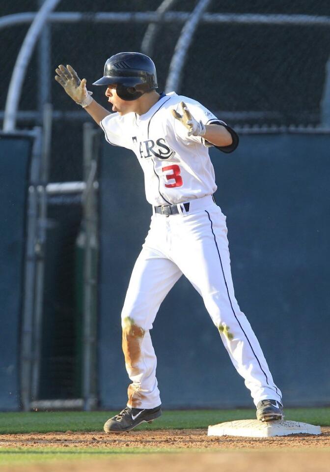 Newport Harbor High's Cameron Jabara is fired up after he hit a triple during the fifth inning against Corona del Mar in Game 1 in a Battle of the Bay doubleheader at Anteater Ballpark on Monday. The Sailors scored four runs in the fifth inning.