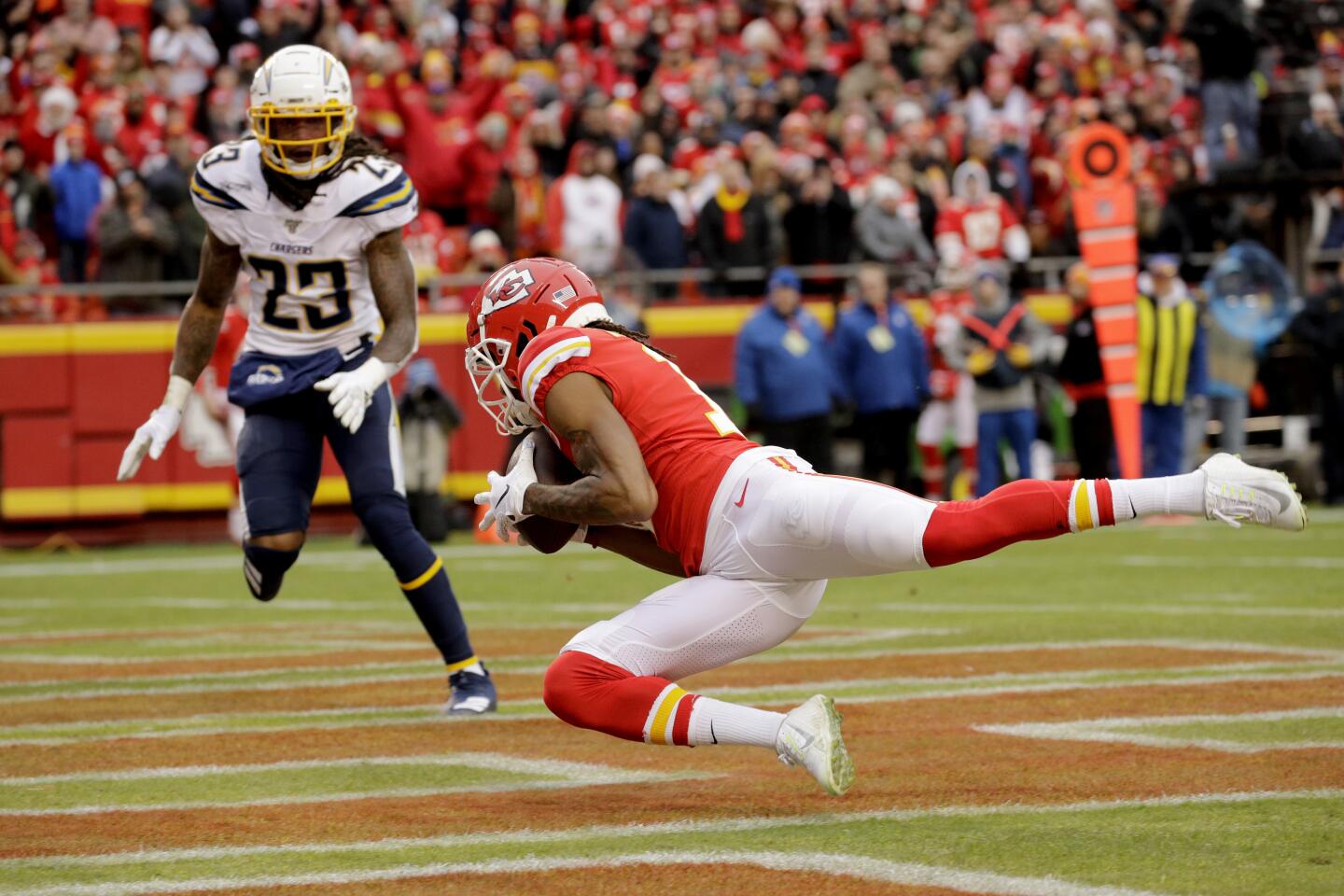 Chiefs receiver Demarcus Robinson (11) makes a touchdown catch in front of Chargers safety Rayshawn Jenkins (23) during a game Dec. 29.