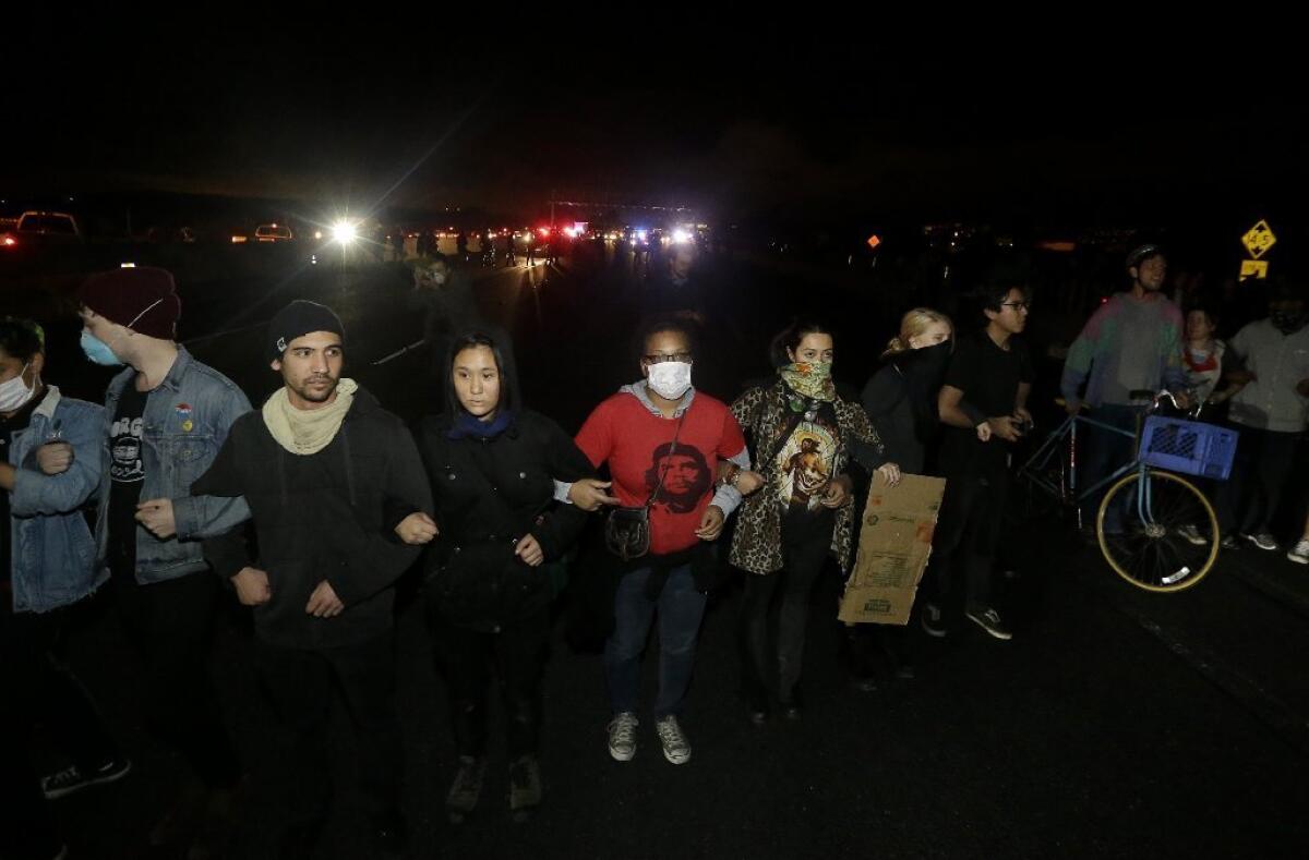 UC Berkeley students block freeway traffic during a protest over the deaths of two black men at the hands of police in Missouri and New York. Cal was one of many colleges and universities where such protests were held.