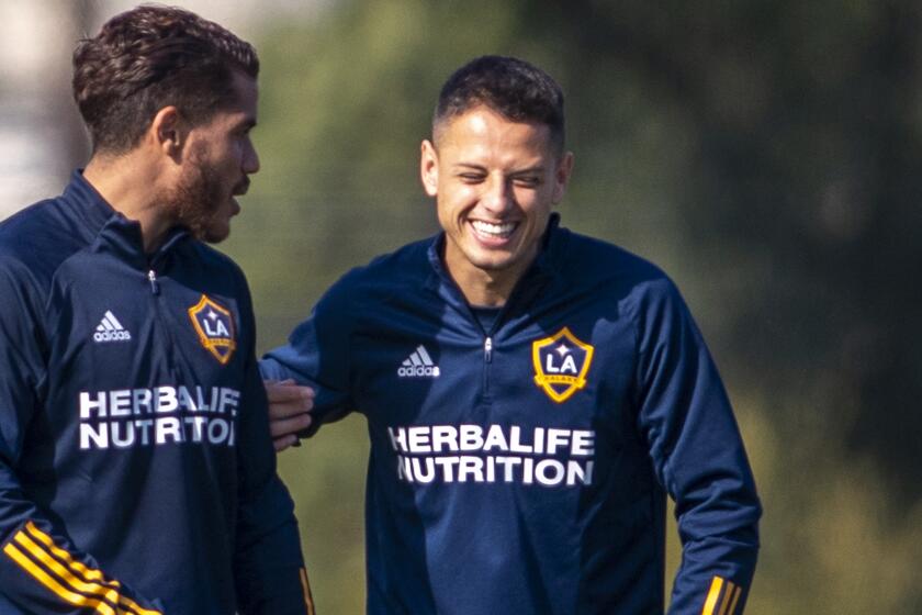 CARSON, CALIF. -- THURSDAY, JANUARY 23, 2020: LA Galaxy’s new player Javier 'Chicharito' Hernandez, center, jokes with midfielder Jonathan dos Santos, left, as he meets coaches and teammates before being formally introduced at a news conference at Dignity Health Sports Park in Carson, Calif., on Jan. 23, 2020. (Allen J. Schaben / Los Angeles Times)