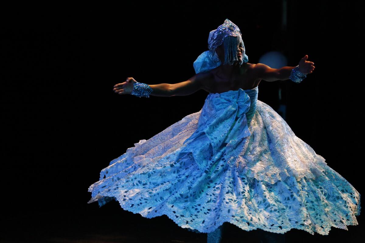 A dancer twirls with arms extended