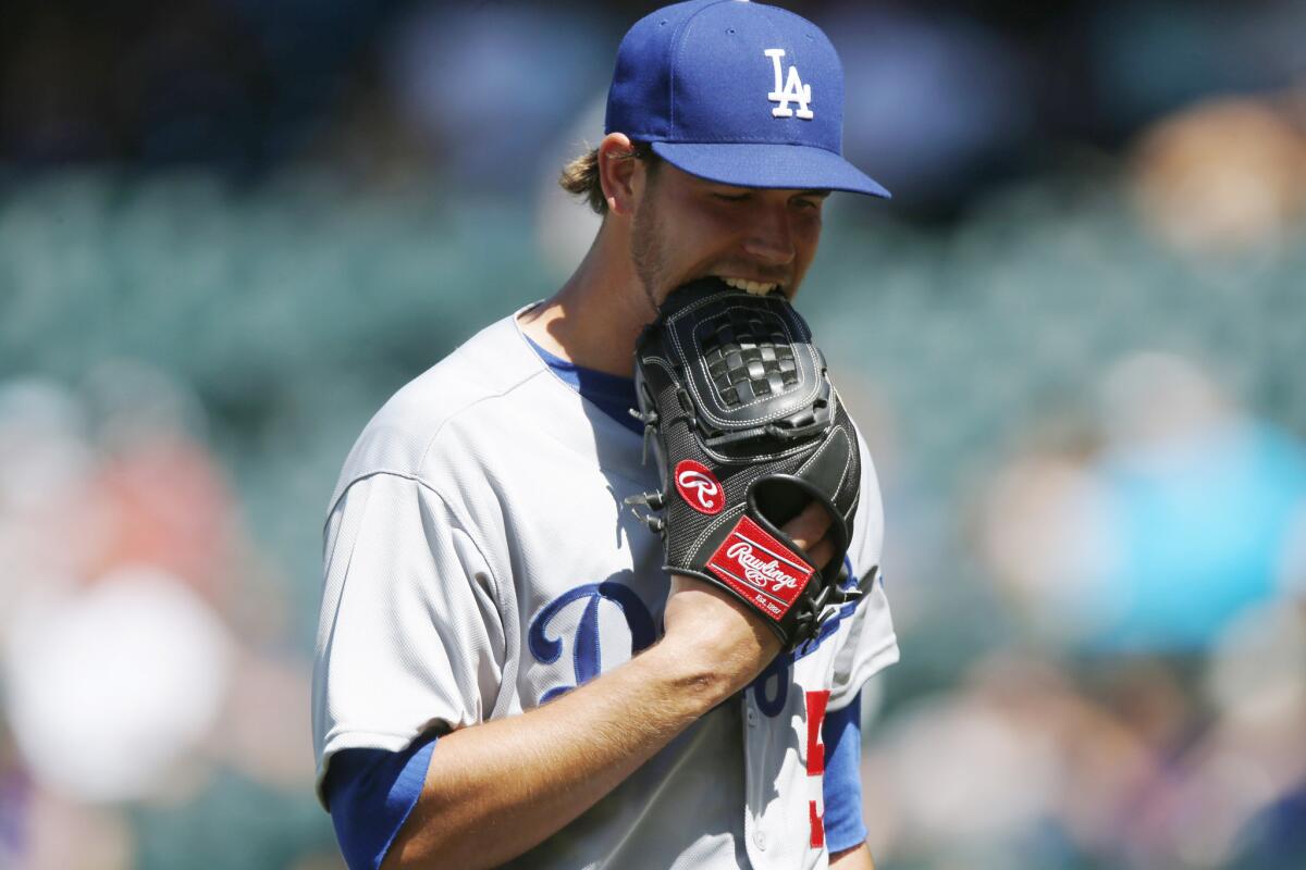 Dodgers relief pitcher Ian Thomas gave up two runs in the fifth inning against the Rockies.