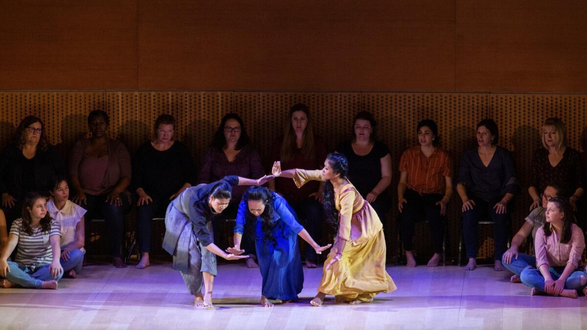 Cambodian dancers Nam Narim, left, Sam Sathya and Chumvan Sodhachivy perform in Peter Sellars' production of Stravinsky's "Persèphone," with Esa-Pekka Salonen conducting the Los Angeles Philharmonic in Walt Disney Concert Hall on Thursday night.