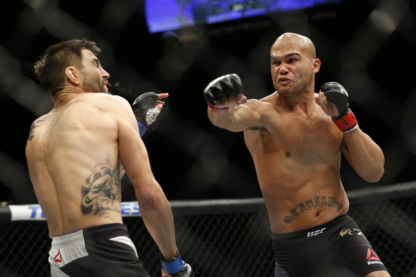 Robbie Lawler, right, sends Carlos Condit reeling with a right during their welterweight championship fight at UFC 195 on Jan. 2 at the MGM Grand.