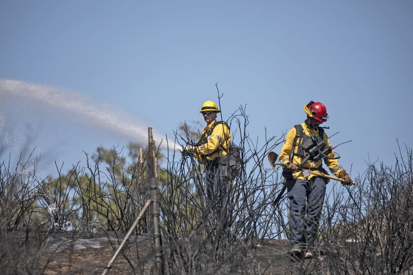 Ramona, CA - September 05: Fire crews work to put out a brush fire that burned about 50 acres on Monday, Sept. 5, 2022 in Ramona, CA. (Ana Ramirez / The San Diego Union-Tribune)