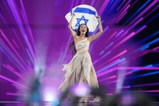 Eden Golan of Israel enters the arena during the flag parade before the Grand Final of the Eurovision Song Contest in Malmo, Sweden, Saturday, May 11, 2024. (AP Photo/Martin Meissner)