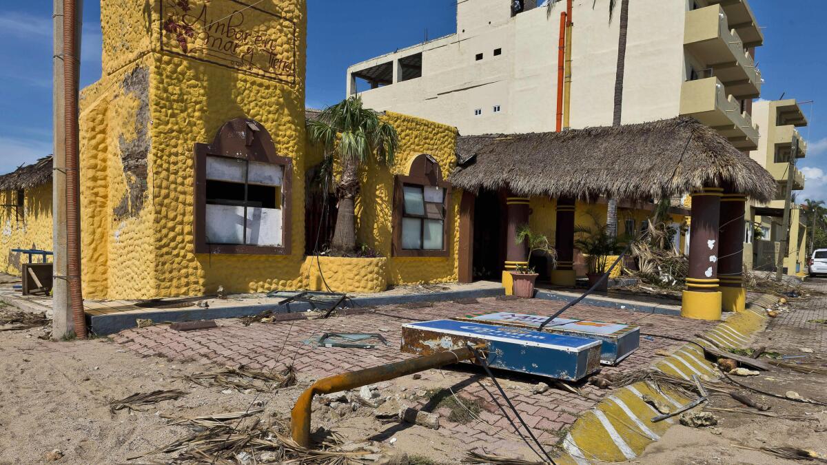 The sign outside a restaurant in Barra de Navidad, Jalisco state, is flattened on Oct. 24, 2015, one day after Hurricane Patricia hit the shore of Mexico.