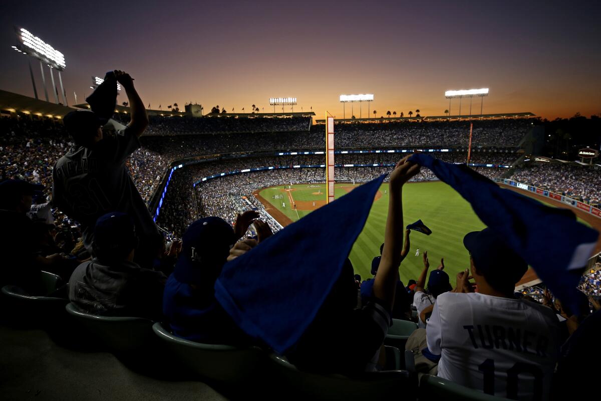 Fans wave towels during Game 2 of the 2017 World Series between the Dodgers and Houston Astros at Dodger Stadium.