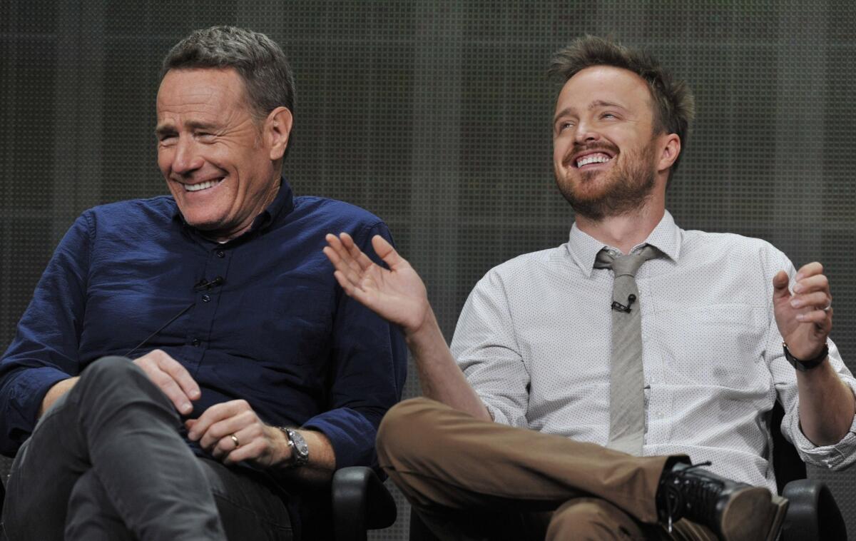 Bryan Cranston, left, and Aaron Paul, cast members in the television series "Breaking Bad," share a laugh onstage during AMC's Summer 2013 TCA press tour at The Beverly Hilton Hotel on Friday, July 26, 2013, in Beverly Hills, Calif.