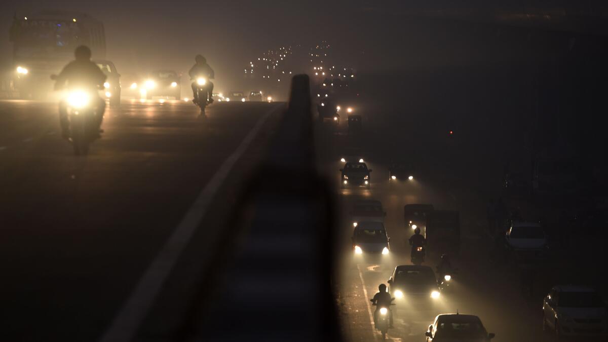 Traffic moves through heavy smog in Faridabad, a suburb of New Delhi.