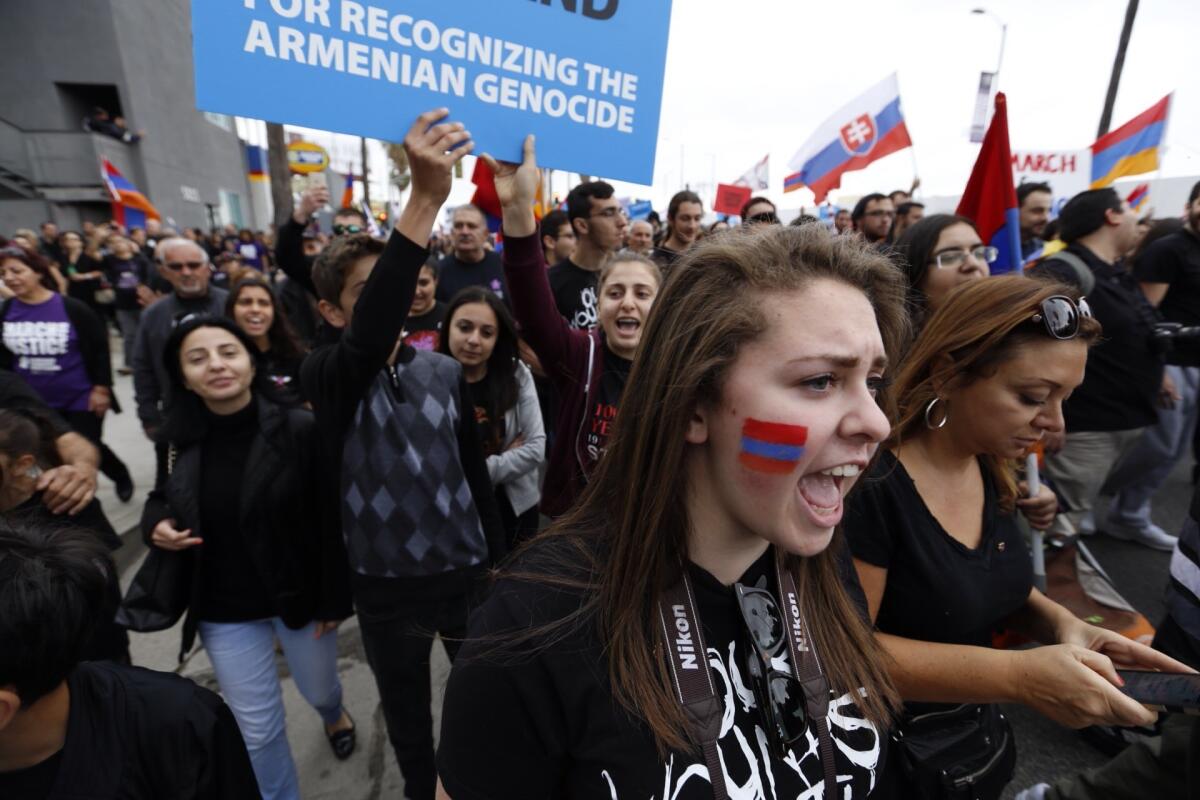 Shannon Blanck, right, chants as thousands march west on Sunset Blvd. at the beginning of a six mile march marking 100th anniversary of Armenian Genocide by Ottoman Turkish government.