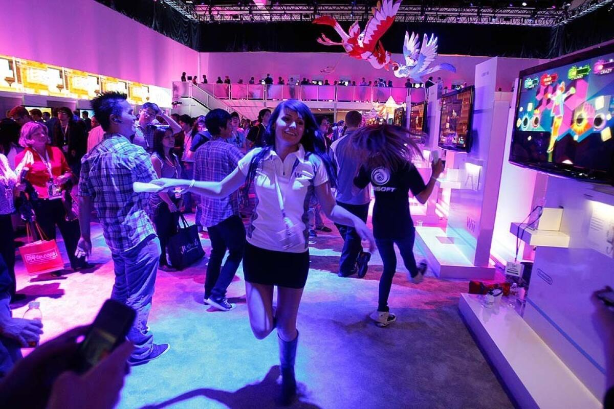 Chloe Zak of Nintendo dances along with the game "Just Dance 3" at the Electronic Entertainment Expo at the Los Angeles Convention Center.