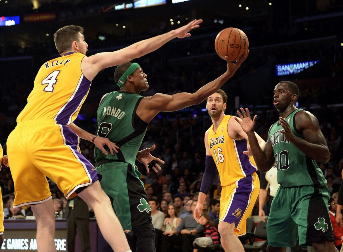 Lakers forward Ryan Kelly tries to block a reverse layup by Celtics point guard Rajon Rondo in the first half Friday night at Staples Center.