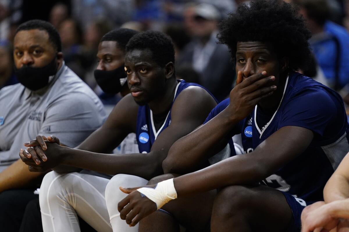 Saint Peter's Clarence Rupert, right, and Fousseyni Drame watch from the bench during the second half of Sunday's loss.
