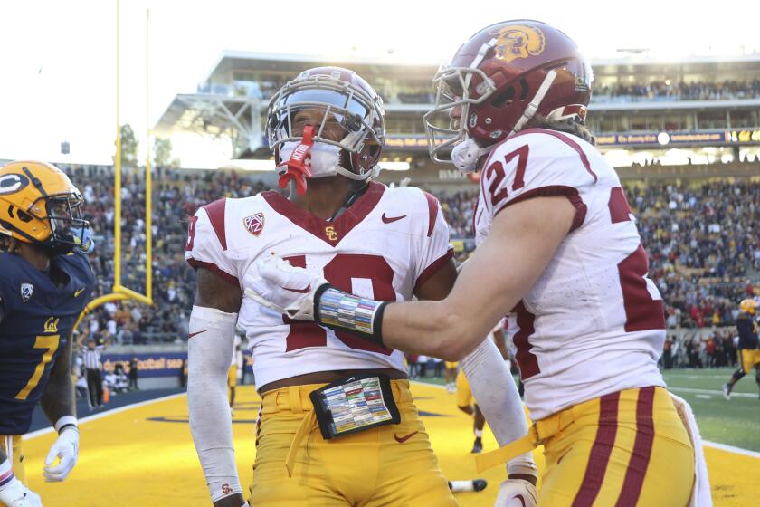 Southern California defensive end Jamil Muhammad (10) celebrates with safety Bryson Shaw.