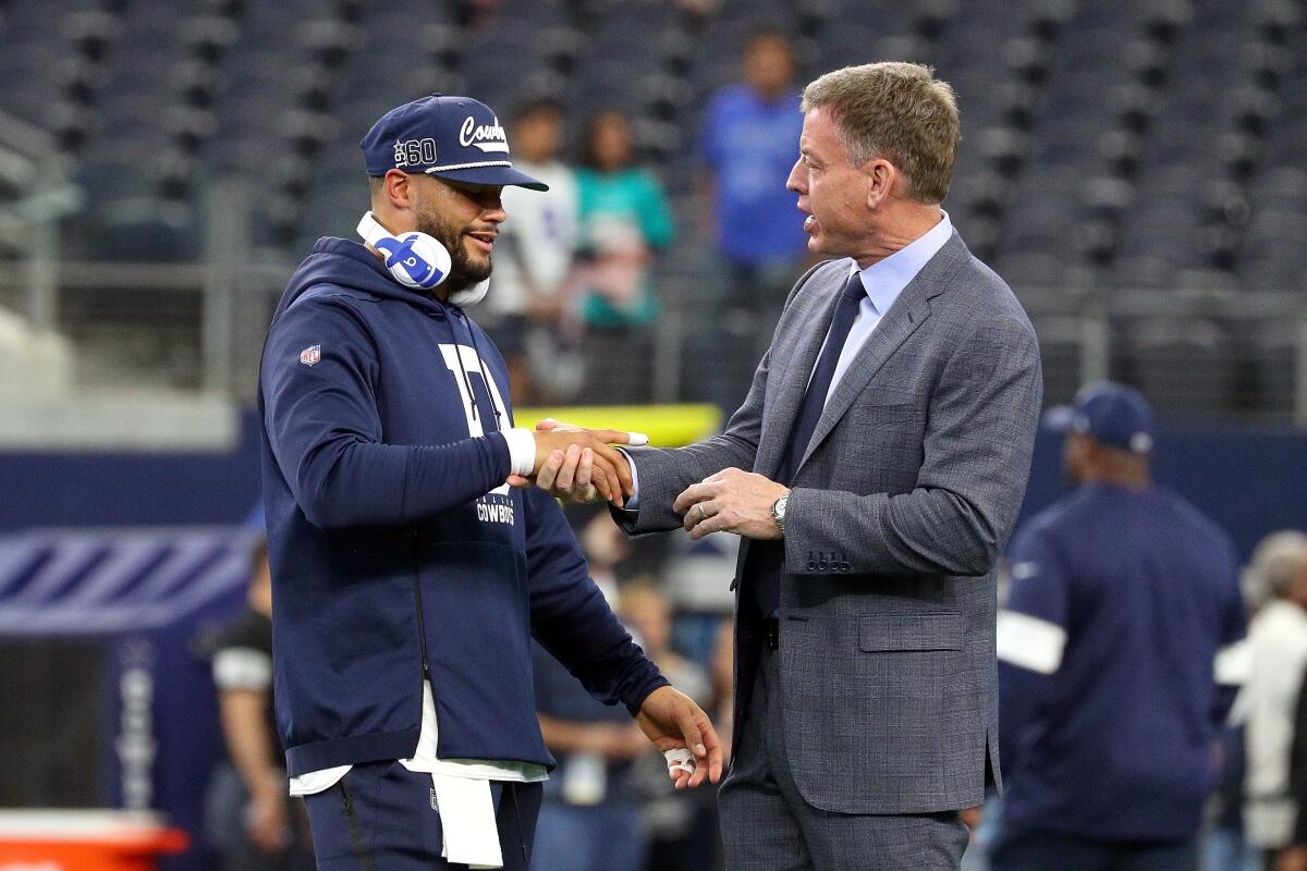 Dallas Cowboys quarterback Dak Prescott shakes hands with Fox Sports NFL analyst and former Cowboys quarterback Troy Aikman.
