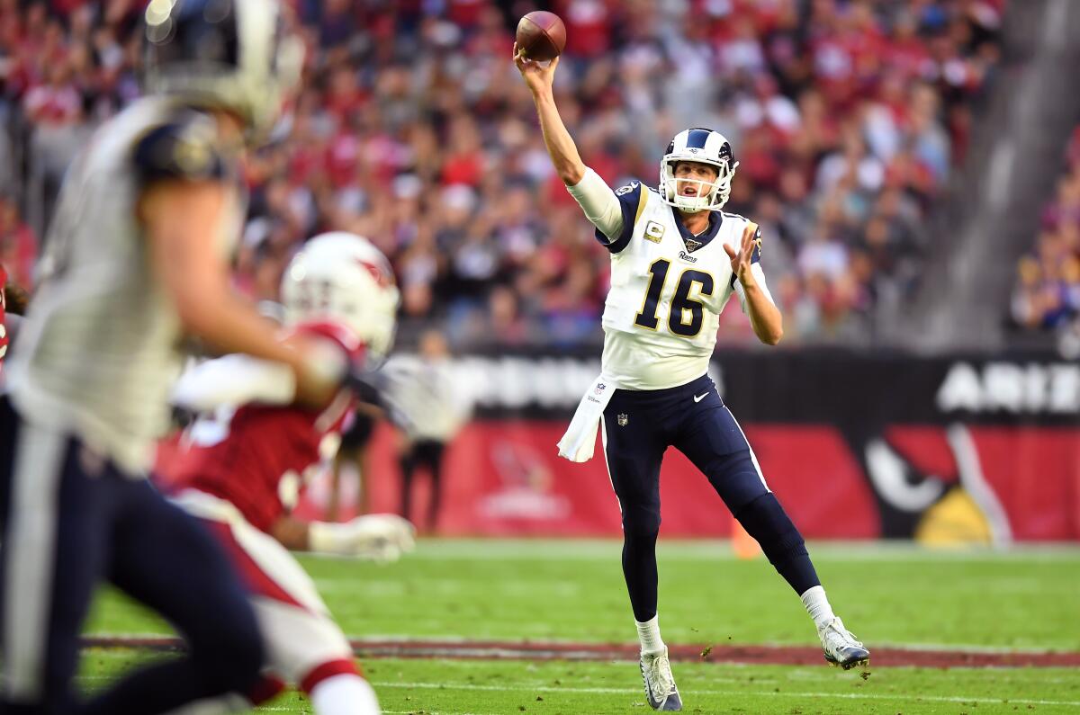 Rams quarterback Jared Goff completes a pass to receiver Cooper Kupp during the first quarter of a 34-7 victory over the Arizona Cardinals at State Farm Stadium on Sunday.