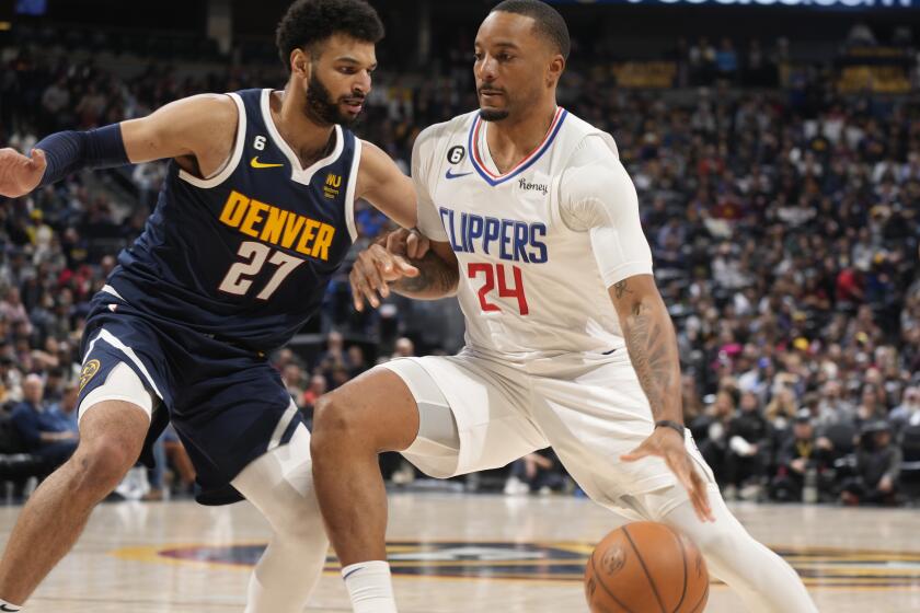 Los Angeles Clippers forward Norman Powell, right, drives as Denver Nuggets guard Jamal Murray defends during the second half of an NBA basketball game Thursday, Jan. 5, 2023, in Denver. (AP Photo/David Zalubowski)