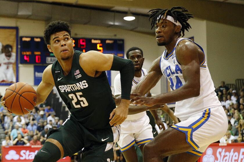 Michigan State forward Malik Hall (25) tries to get around UCLA forward Jalen Hill (24) during the first half of an NCAA college basketball game Wednesday, Nov. 27, 2019, in Lahaina, Hawaii. (AP Photo/Marco Garcia)