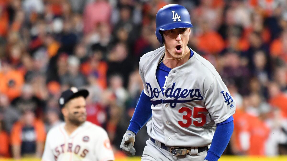 Dodgers first baseman Cody Bellinger celebrates as he round the bases following a three-run home run against the Astros during the fifth inning of Game 5.