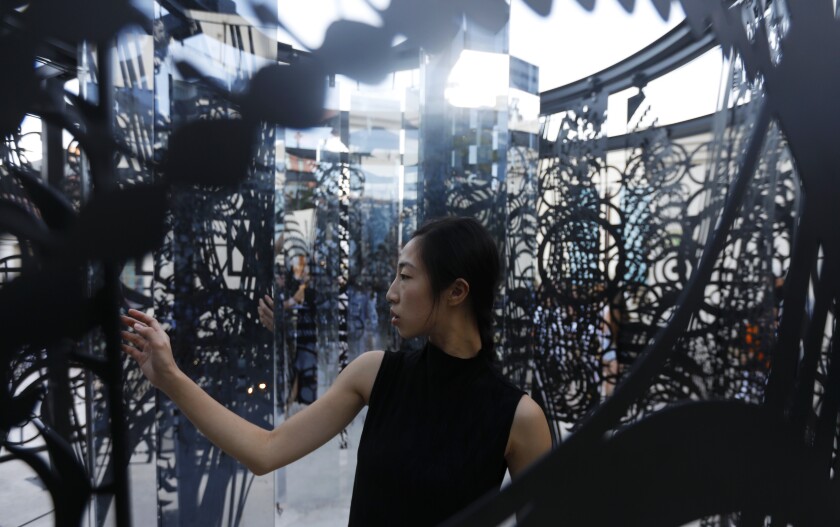 Haihua Chiang, 25, of Assembly Dance group moves around the Elizabeth Turk exhibition “Tipping Point.”