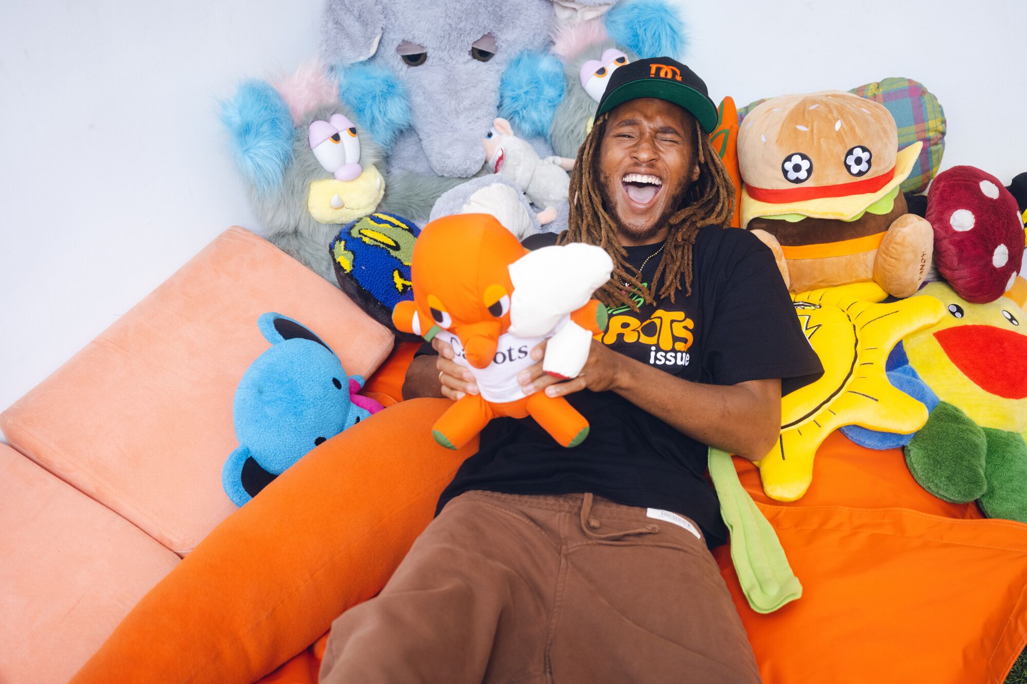 Anwar Carrots holds a stuffed animal at his studio.
