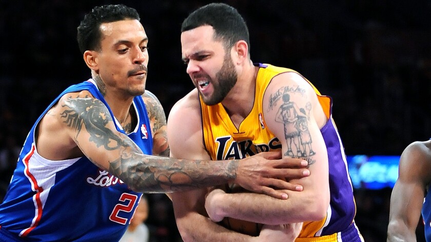 Clippers forward Matt Barnes, left, tries to steal the ball away from Lakers guard Jordan Farmar during a game in March. Farmar has agreed to a two-year contract with the Clippers.
