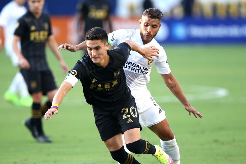 CARSON, CALIFORNIA - OCTOBER 03: Eduard Atuesta #20 of Los Angeles FC and Jonathan dos Santos.