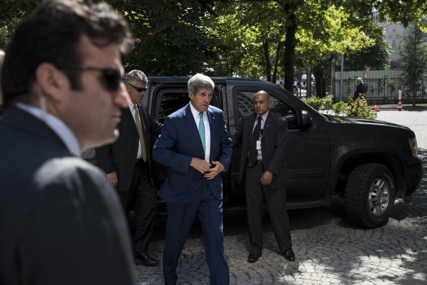 Secretary of State John Kerry, center, arrives for a meeting with Turkey's foreign minister at the Ministry of Foreign Affairs in Ankara, Turkey, on Friday.