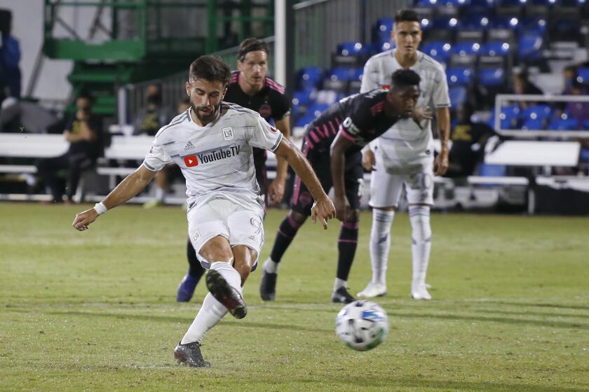Los Angeles FC forward Diego Rossi (9) scores on a penalty kick against the Seattle Sounders during the first half of an MLS soccer match in Kissimmee, Fla., Monday, July 27, 2020. (AP Photo/Reinhold Matay)