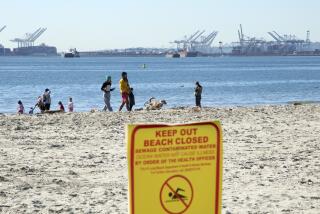 LONG BEACH, CA - JANUARY 02: A sign a Rosie's Dog Beach in Long Beach warn visitors of the contaminated water. Southland beaches remain closed due to a raw sewage spill in the Dominguez Channel. The beaches will remain closed until water quality levels meet acceptable standards. Photographed at Rosie's Dog Beach on Sunday, Jan. 2, 2022 in Long Beach, CA. (Myung J. Chun / Los Angeles Times)