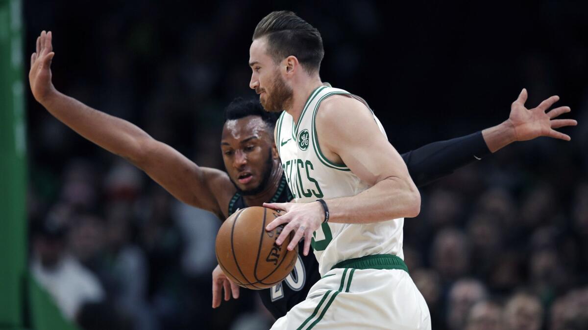 Boston Celtics forward Gordon Hayward, right, tries to drive past Minnesota Timberwolves guard Josh Okogie, front, during the first quarter.