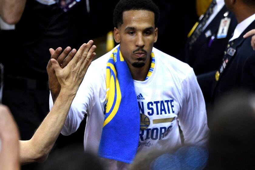Warriors reserve guard Shaun Livingston gets a high-five from a fan as he enters the court Thursday night in Oakland.