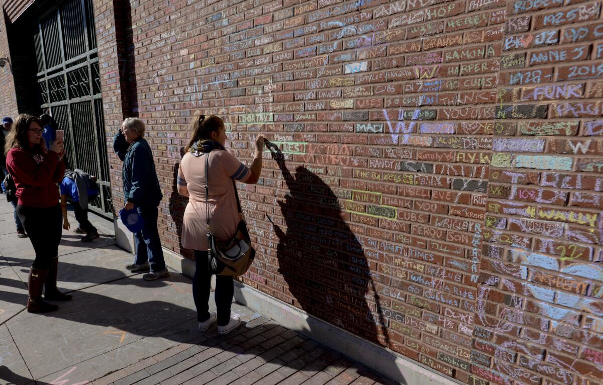 Fans write on the walls of Wrigley Field in Chicago.