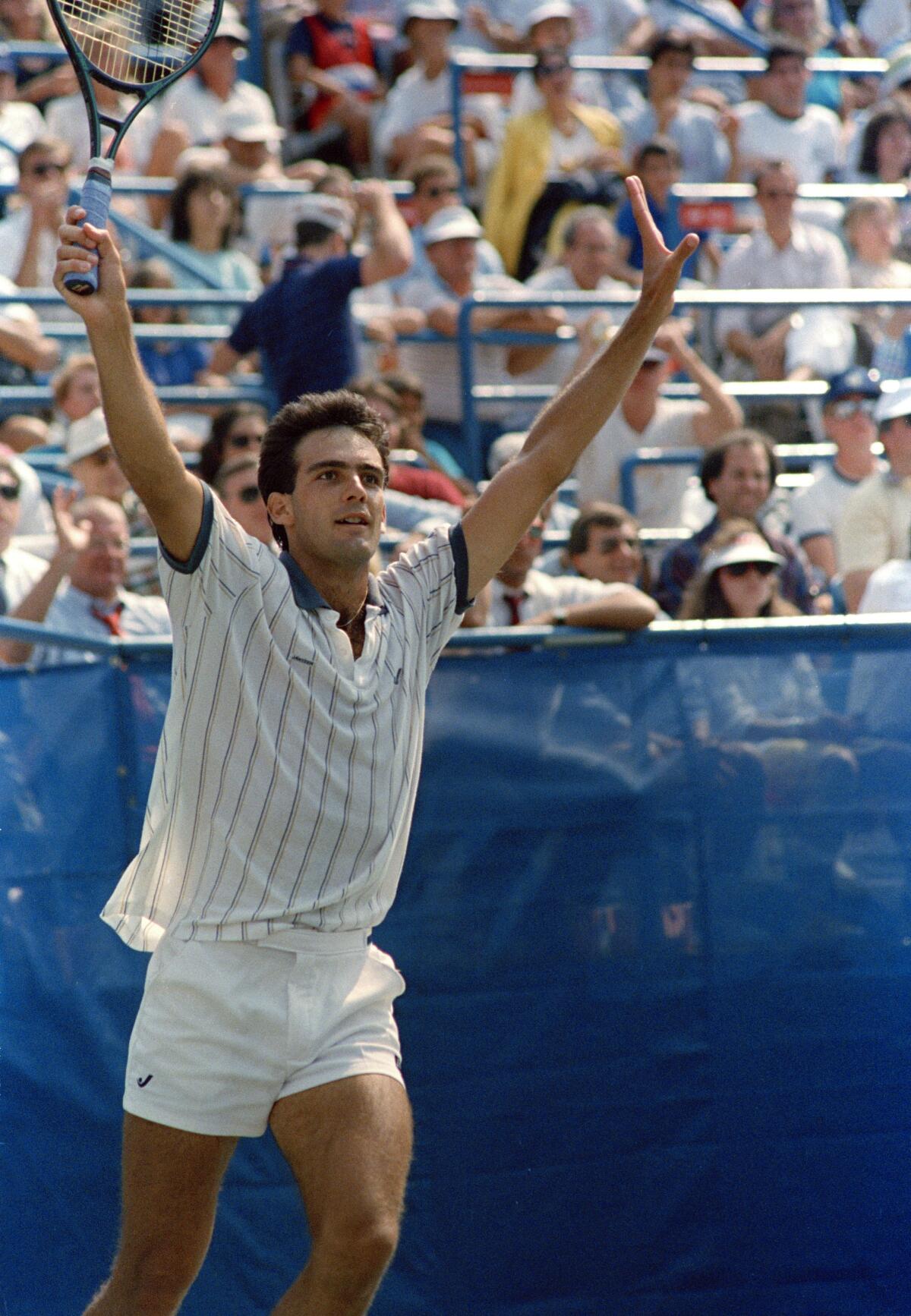 Paul Annacone throws up his arms in jubilation after he eliminated John McEnroe.