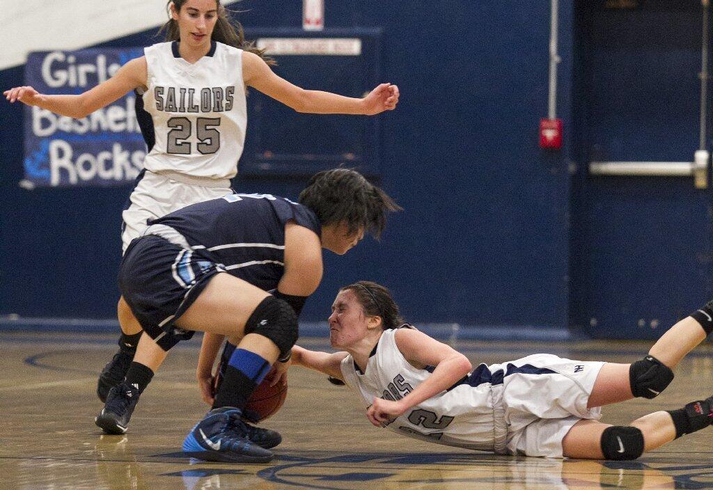 Newport Harbor High's Bela Raimondi battles for a loose ball against Corona del Mar's Kelly Tam during a game on Tuesday.