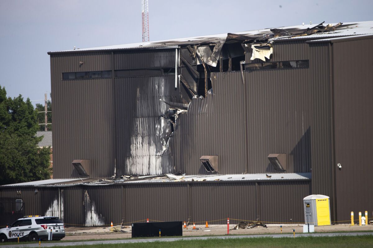 FILE - In this June 30, 2019, file photo, damage is seen to a hangar after a twin-engine plane crashed into the building at Addison Airport in Addison, Texas. The pilot's failure to control a small airplane when it lost thrust in one of two engines seconds after takeoff in suburban Dallas led to the crash that killed all 10 people aboard, federal officials said in a report Tuesday, May 18, 2021. (Shaban Athuman/The Dallas Morning News via AP, File)