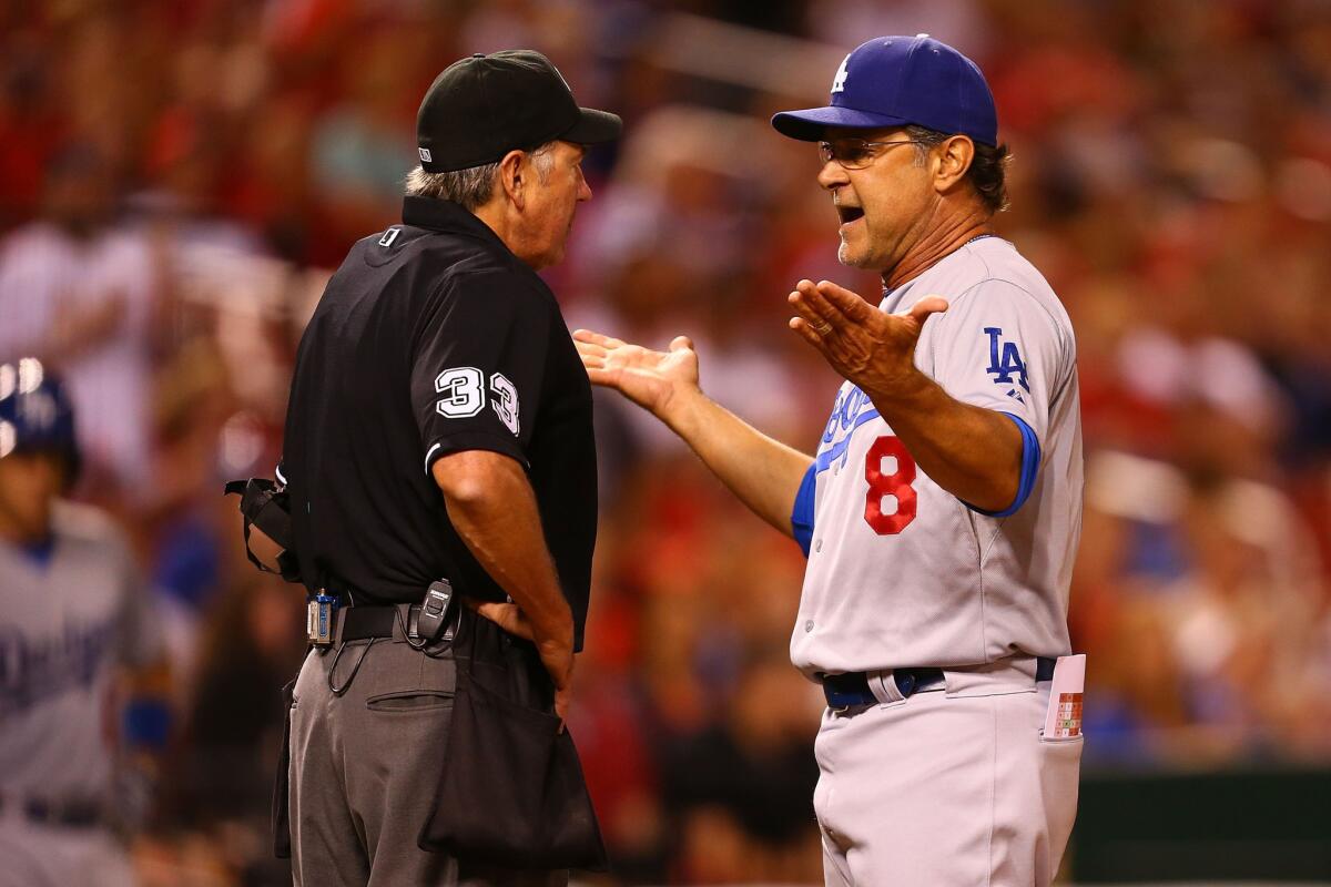 Dodgers Manager Don Mattingly argues with home plate umpire Mike Winters after getting ejected for complaining about the strike zone in the seventh inning Friday night in St. Louis.