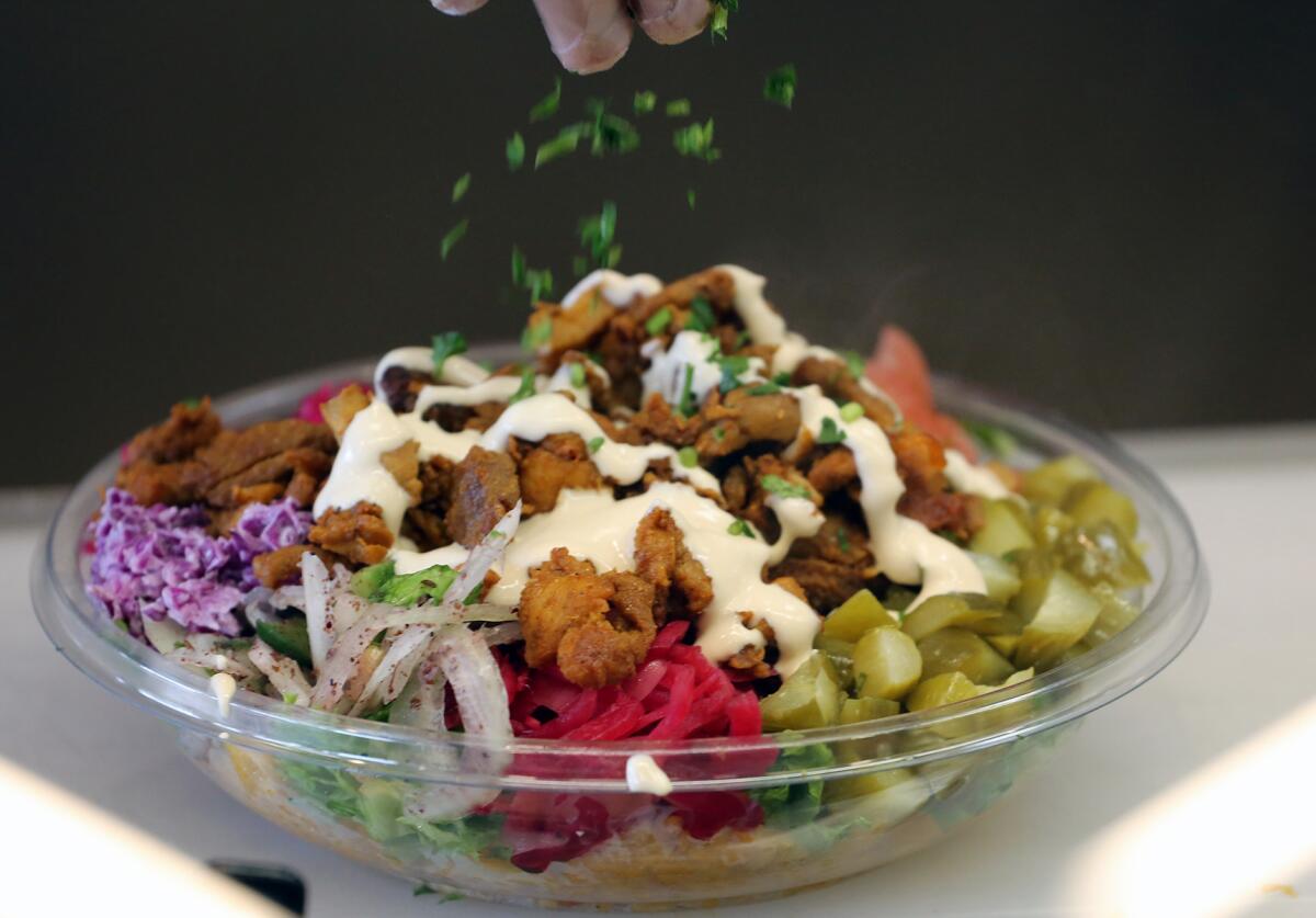 Sababa chicken bowl with vegetables, tahini sauce and sumac spice at Sababa Falafel Shop.