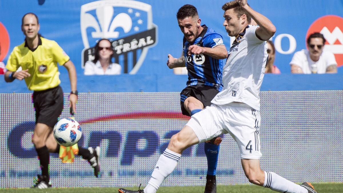 Galaxy's Dave Romney, right, challenges Montreal's Alejandro Silva during a game on May 21.