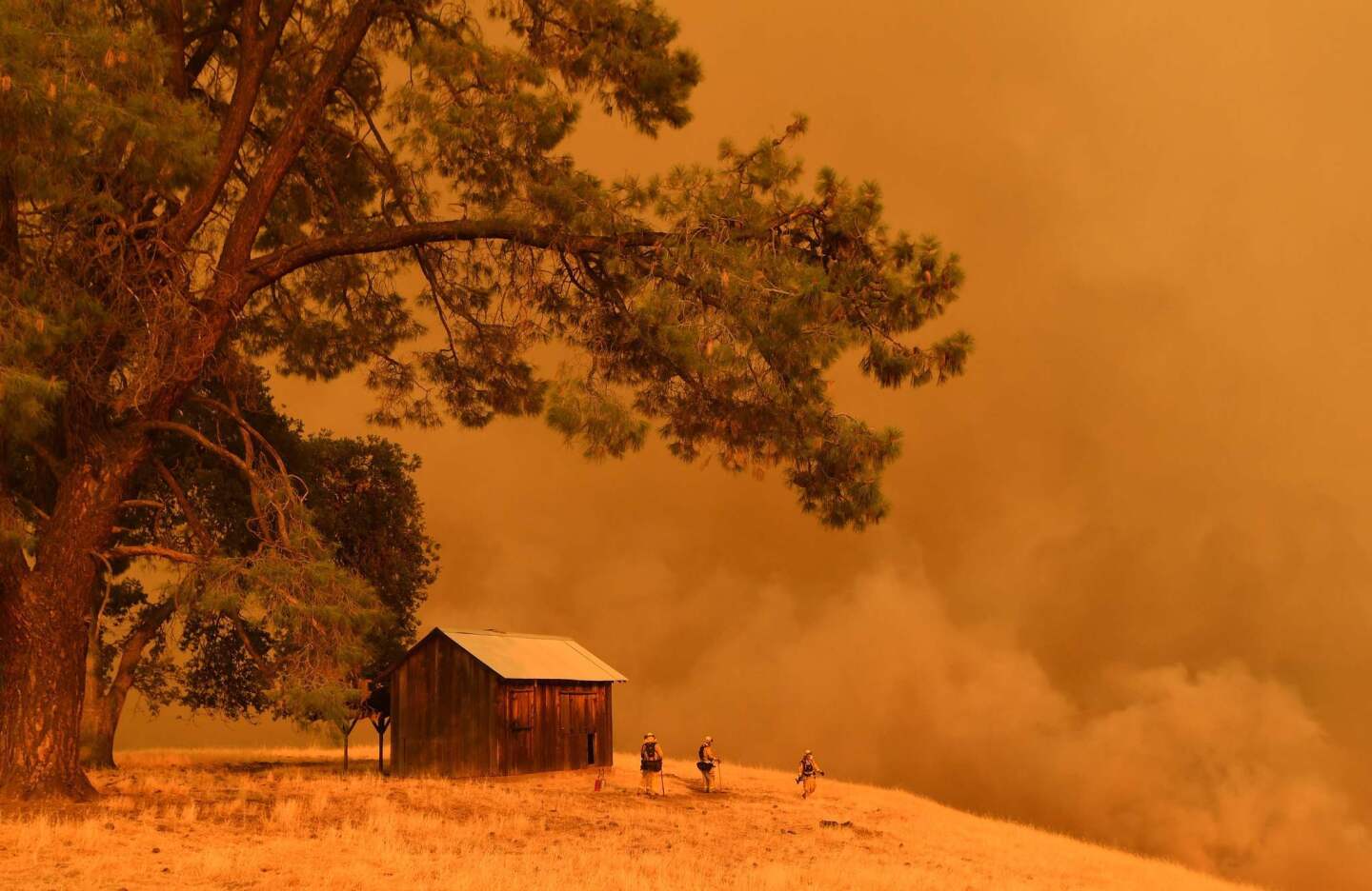 Firefighters watch as flames from the County fire climb a hillside in Guinda. California authorities have issued red flag weather warnings and mandatory evacuation orders after a series of wildfires fanned by high winds and hot temperatures ripped through thousands of acres.
