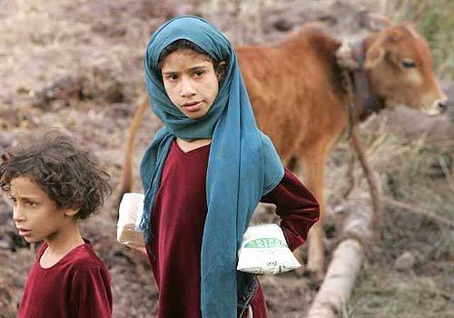 An earthquake victim holds relief material near Uri, about 110 kilometers (69 miles) north of Srinagar, India. Soldiers and volunteers used bulldozers and bare hands Sunday to pull survivors and bodies from the rubble of houses and buildings toppled by a powerful earthquake in South Asia that killed 600 people in India's portion of the Kashmir region.