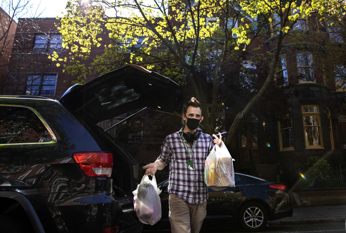 Matt Gillette, a 36 year-old Instacart shopper, makes a grocery delivery in Washington, D.C.