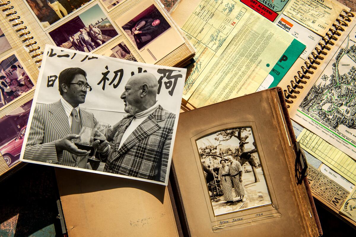 A black and white photo of Noritoshi Kanai and Harry Wolff is showcased among a plethora of photos and documents.