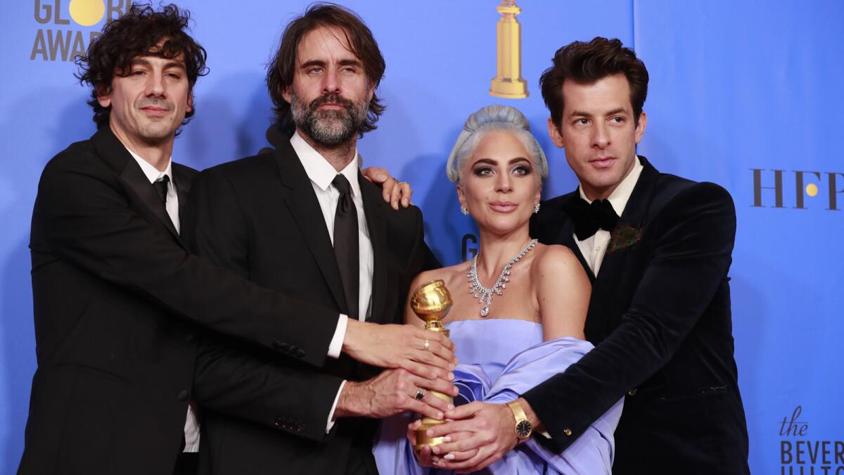 Golden Globe winners Anthony Rossomando, left, Andrew Wyatt, Lady Gaga and Mark Ronson for the song “Shallow” from “A Star is Born.”