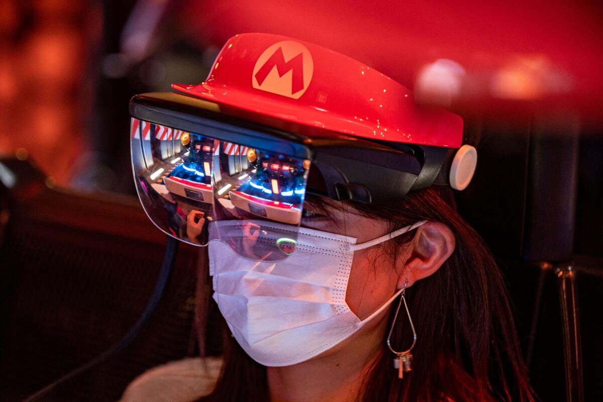 A fan of Universal Studios Japan wears themed augmented reality goggles on the "Mario Kart" ride 