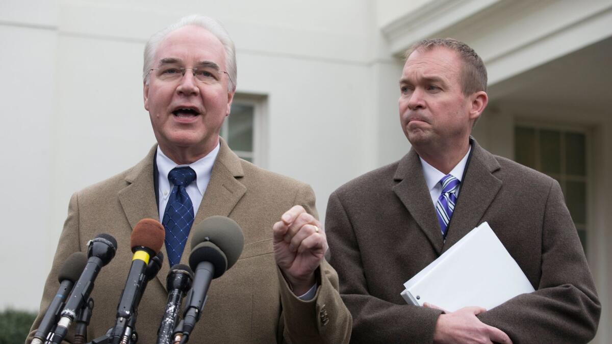 Health and Human Services Secretary Tom Price, left, and White House budget director Mick Mulvaney respond to the release of the Congressional Budget Office's report on the projected cost and effects of the American Health Care Act in Washington on Monday.